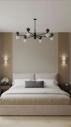 a large bed sitting under a chandelier in a bedroom next to a window