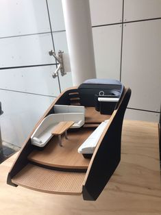 a boat shaped desk with two computers on it's sides and a phone in the middle