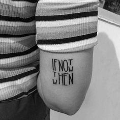 a person with a tattoo that says if not when on their arm, it's written