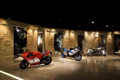 three motorcycles are parked in a showroom