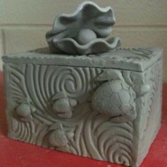 a stone box sitting on top of a red table