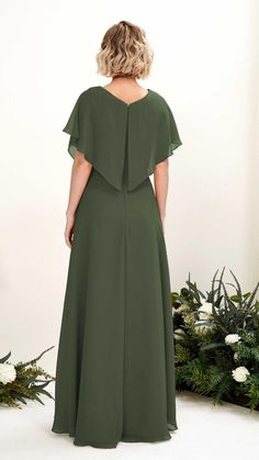 the back of a woman wearing a dark green dress with short sleeves and an open neckline