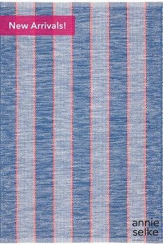 a blue and red striped towel with the words new arrivals on it's side