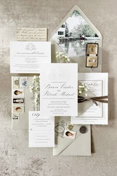 the wedding stationery is laid out on top of each other, including two envelopes and