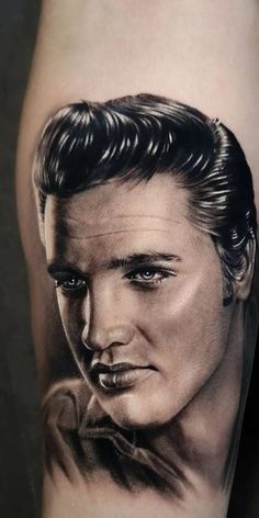 a man's arm with a portrait of elvis presley on it