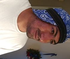 a man wearing a bandana and looking at the camera