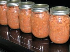 several jars filled with food sitting on top of a stove