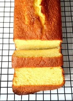 a loaf of pound cake sitting on top of a cooling rack with slices cut out