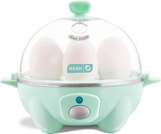 an egg cooker with four eggs in it's glass dome on white background