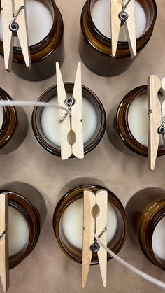 several clocks made out of wood are sitting on plates with forks and spoons in front of them