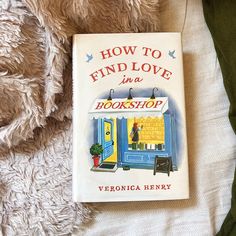 the book how to find love in a bookshop by veronica henry on a bed