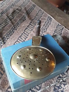 a metal grater sitting on top of a blue box