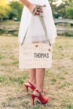 a woman in red high heels holding a sign