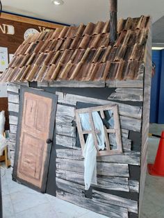 a doll house made out of wooden boards