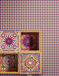 an intricately designed wall with colorful tiles on it