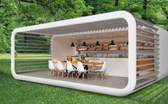 an outdoor dining area in the shape of a shipping container with chairs and tables inside