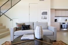 a living room filled with furniture and a stair case