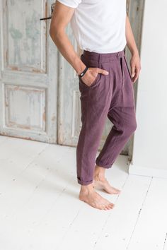 "Linen drop-crotch pants for men are a part of your casual outfit or any specific occasion. A loose cut around the thigh with a narrow shape through the leg feels very comfortable even during the hottest days. The above ankle length of the pants looks good with sandals as well as sneakers. These stylish pleated pants have four pockets - one at each side and two in the back. You will be beloved to wear them! DETAILS: - OEKO-TEX certified product (Sustainable Textile) - Zip fly with two buttons cl Mens Lenin Pants, Engagement Photo Outfits For Men Summer, Cuffed Pants Men, Linen Pleated Pants, Bohemian Relaxed Fit Straight Leg Pants, Bohemian Straight Leg Pants With Relaxed Fit, Bohemian Straight Leg Relaxed Pants, Bohemian Straight Leg Bottoms With Pockets, Bohemian Bottoms With Relaxed Fit And Straight Leg