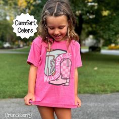 You will love this Christian t-shirt for girls. It is based on the Bible verse 2 Corinthians 5:7. It says, walking by faith not by sight.  There is an adorable retro cowgirl boot graphic on the front of the tee to go along with the scripture. Share your faith in Jesus with others through your apparel. These comfort colors brand tees are so soft and comfortable for children and adults. Find the adult version of this shirt here: https://www.etsy.com/listing/1750337961/christian-western-shirt-for-women -100% combed ringspun cotton -Medium fabric (6.1 oz/yd² (206.8 g/m -Classic Fit -Sew-in twill label T shirt Care instructions: Machine wash: cold (max 30C or 90F); Do not bleach; Tumble dry: low heat; Iron, steam or dry: low heat; Do not dryclean. Fit & Sizing: Please lay one of your shirts at Pink Slogan T-shirt For School, Casual Pink T-shirt For School, Christian Cowgirl, Christian Kids Shirts, Walking By Faith, Christian Concert, Retro Cowgirl, By Faith Not By Sight, 2 Corinthians 5 7