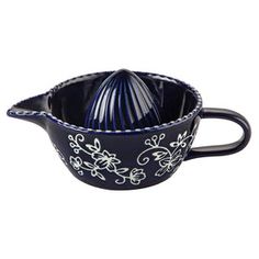 a black and white ceramic bowl with blue flowers on the rim, in front of a white background