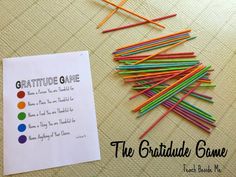 a pile of colored pencils sitting on top of a table next to a piece of paper