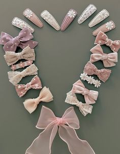 several different types of hair clips with bows and pearls on them, all in pastel colors