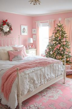 a bedroom decorated in pink and white with a christmas tree on the far side of the bed