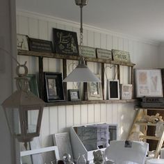 a dining room table with chairs and pictures on the wall