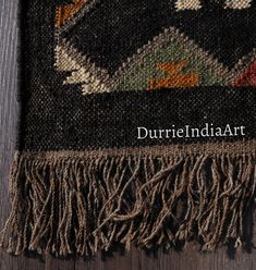 an old rug with fringes on top of it and the words durrieindia art