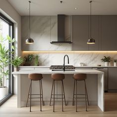 three stools sit at an island in the middle of a kitchen