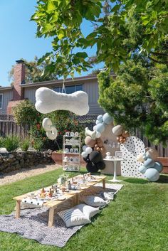 an outdoor party with balloons and decorations