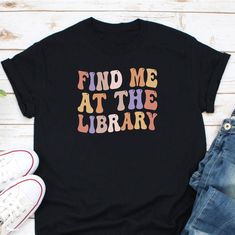 Find Me At The Library Shirt, Librarian Shirt, Book Lover Shirt, School Librarian Gift, Book Nerd Shirt, Book Read Shirt, Library Assistant Ordering Process for our valued customers ~ Please follow all steps to place an order. ~ Please select the hoodie type and size. ~ Please select color of the hoodie from drop down options. ~ If you want to purchase more than 1 , add current item to your cart and then you can click back, add more items for each product. ~ Once all your desired items , you can Library Assistant, Library Shirt, Book Nerd Shirts, Nerd Shirt, Librarian Shirt, School Librarian, Gifts For Librarians, Reading Shirts, Fabric Letters