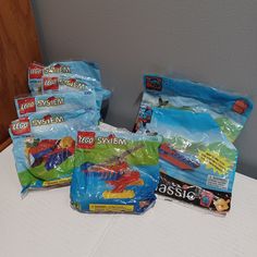 several bags of legos are sitting on a table