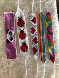 four beaded bookmarks with ladybugs, panda, and hearts on them