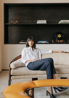 a woman sitting on top of a couch in a living room