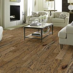 a living room filled with furniture and a fire place in the middle of the floor