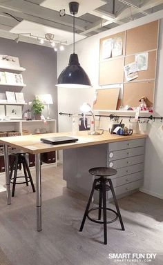 an office with two desks and stools in front of the work area is shown