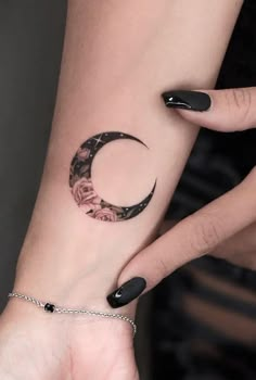 a woman's arm with a crescent tattoo on the left side of her wrist