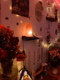 a room filled with lots of lights and flowers in vases next to a mirror