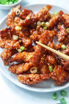 chicken wings with chopsticks on a white plate