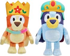 two stuffed animals with crowns on their heads and one is wearing a blue, orange and yellow outfit