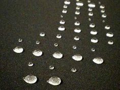 several drops of water sitting on top of a table