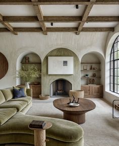 a living room filled with furniture and a fire place in the middle of a room