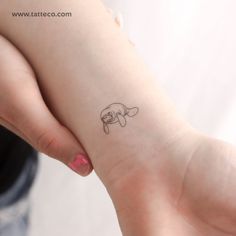 a small dog tattoo on the wrist