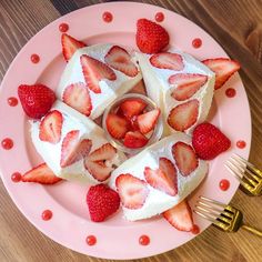 a pink plate topped with slices of cake covered in strawberries