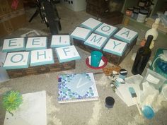 several boxes with letters on them sitting on the floor next to bottles and other items