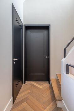 an open door leading to another room in a house with wood floors and white walls