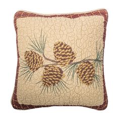 a decorative pillow with pine cones on it