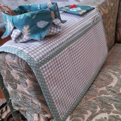 a suitcase sitting on top of a couch in a living room