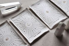 four white plates with decorative designs on them